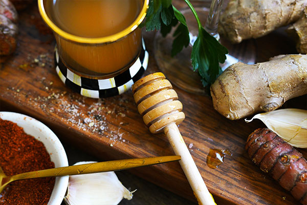 Golden turmeric tonic anti inflammatory immune boosting detox dr a glass of apple cider vinegar sits on a rustic wooden board alongside vibrant ground turmeric fresh turmeric root ginger root and cracked black pepper This anti inflammatory powerhouse combination supports digestion immunity and detoxification Perfect for wellness routines and natural remedy enthusiasts seeking healing benefits from whole ingredients Sourdough afterglow