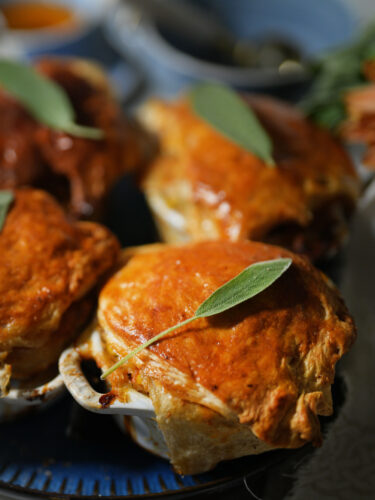 Small classic chicken pot pies baked in cocottes with a golden, flaky crust.