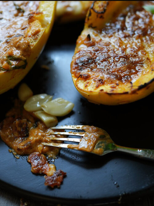 Roasted spaghetti squash boats filled with marinara sauce, topped with Parmesan and fresh basil.