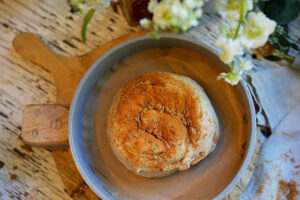 Shaped cinnamon swirl sourdough nestled in a loaf pan, ready to be refrigerated for its cold proof before baking