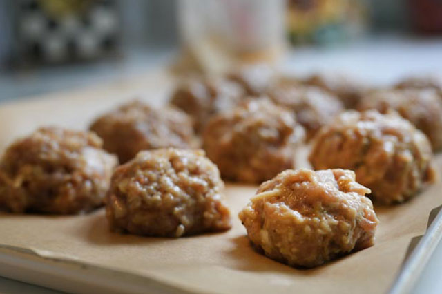 Oven baked turkey meatballs sourdough afterglow recipe neatly shaped turkey meatballs arranged on a parchment lined baking sheet ready to be oven baked until golden and juicy A key step in making healthy high protein meatballs at home Sourdough afterglow Raw turkey meatballs lined up on a parchment-lined baking sheet, ready for the oven