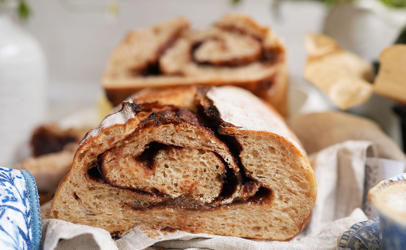 Afterglow swirls cinnamon sourdough bread with brown sugar s a cinnamon swirl sourdough bread cut in half showing off a soft golden crumb and a sugar cinnamon spiral in the center The swirl is tender and defined with a perfect balance of light dough and warm spice Made with stardust whole wheat and yecora rojo 00 flour Sourdough afterglow Cinnamon swirl sourdough bread cut in half showing soft crumb and spiral of brown sugar and cinnamon swirl sourdough bread crumb.