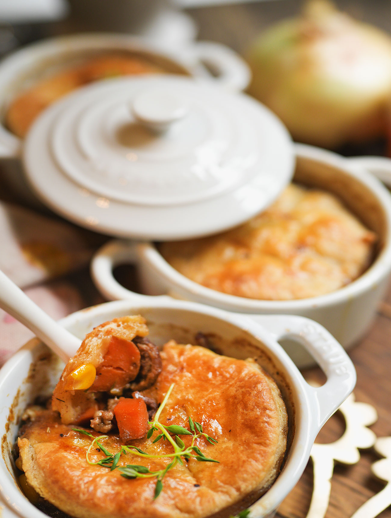 sourdough beef pot pies baked in white cocottes, set on a wooden board with flaky sourdough crust and golden filling—cozy, rustic, and ready to serve.