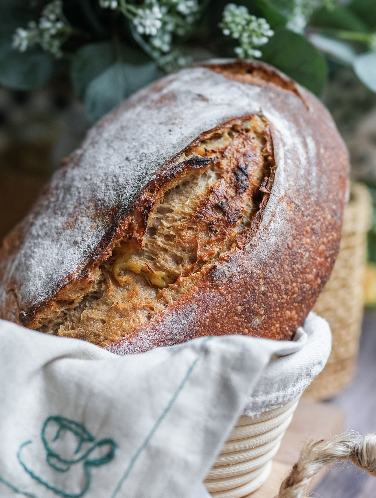 roasted garlic herb sourdough bread in a basket, resting before slicing
