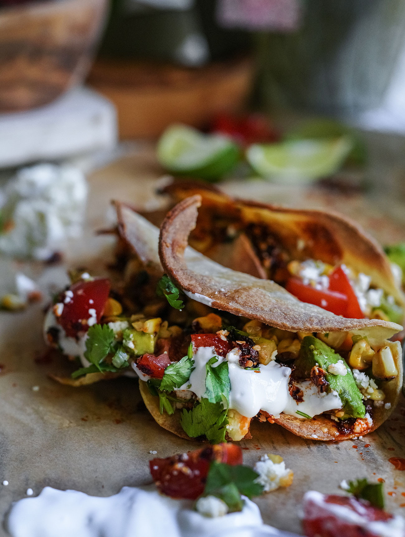 Crispy chicken tacos with corn salsa golden crispy chicken tacos overflowing with creamy corn salsa avocado tomato cotija cilantro and crema Slightly messy totally devouredthis photo captures the final enjoy it moment of the recipe with flavor everywhere and no regrets Sourdough afterglow Messy crispy chicken tacos topped with avocado, corn salsa, chili crunch, crema, and cilantro—partially eaten on parchment paper