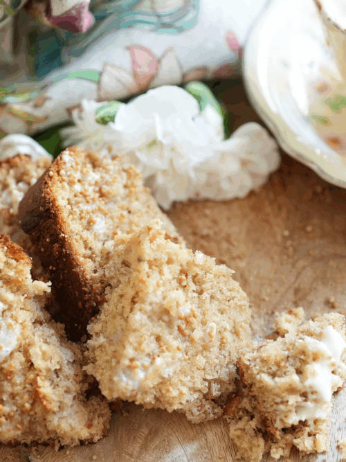 Sourdough banana bread sliced on a wooden cutting board, buttered and ready to eat